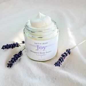 Lavender Body Butter in the window sunshine and three lavender stems