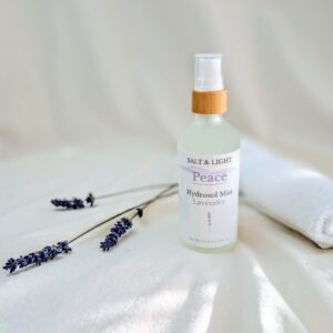 Lavender mist sunshining in the window, white washcloth and lavender stems with a bamboo top